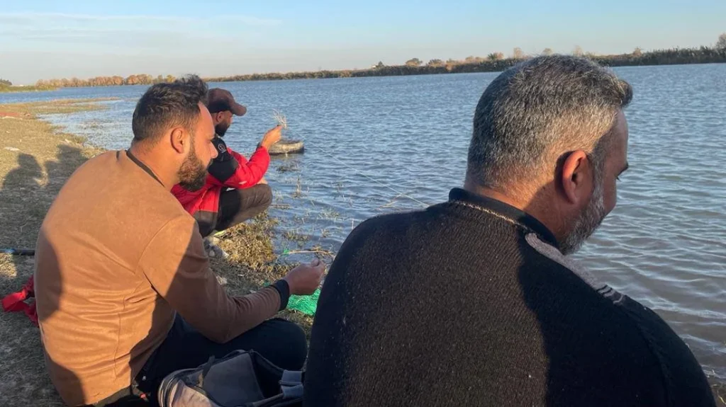 Kut fishermen searching patiently for fish in winter